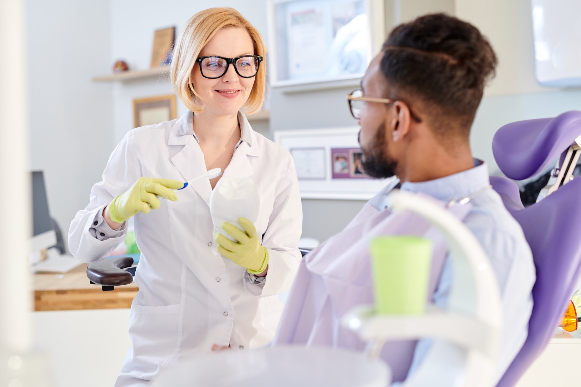 female dentist explaining hygiene rules