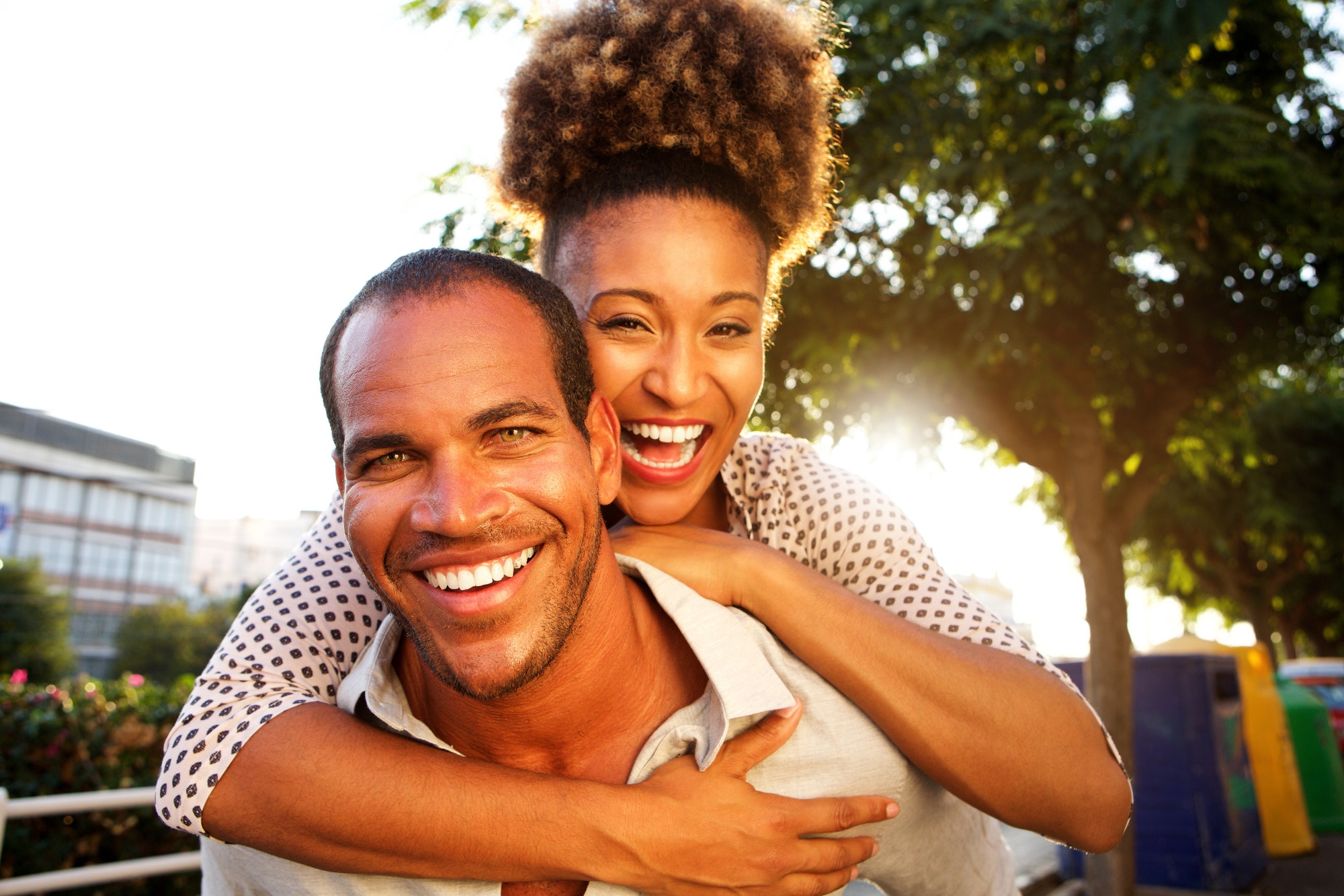 laughing couple with man and woman in embrace