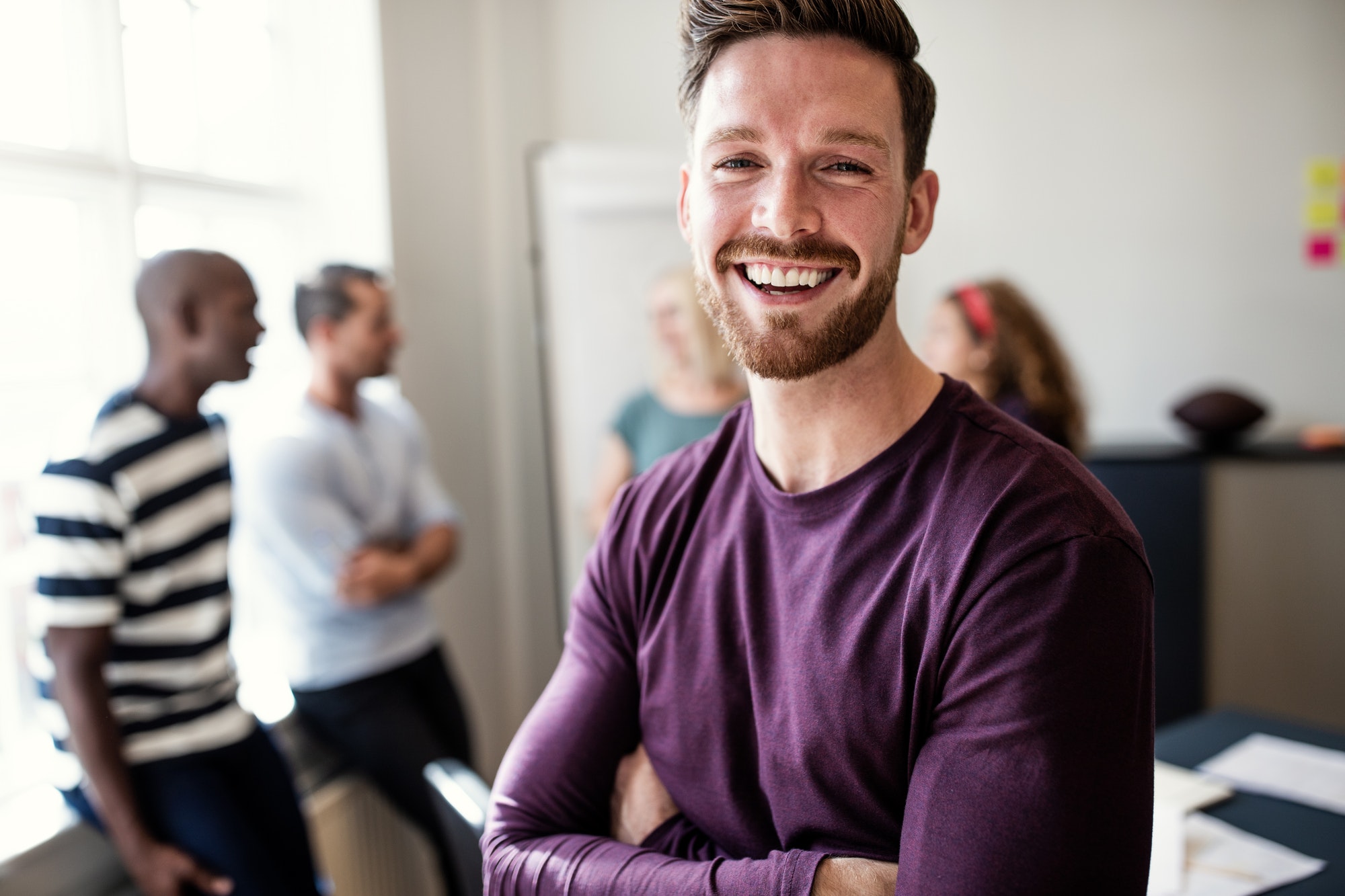 laughing young designer standing in an office after a meeting