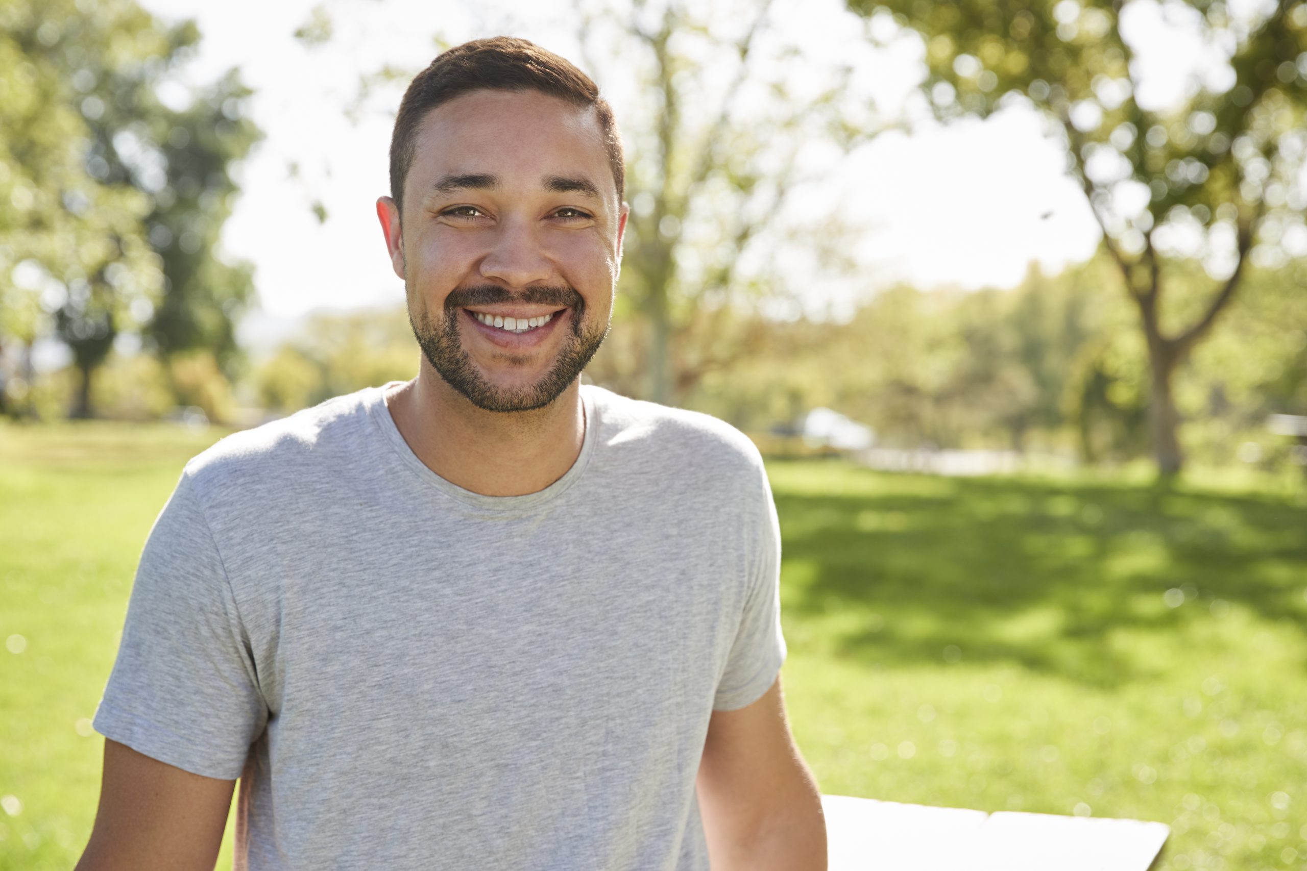 outdoor head and shoulders portrait of smiling JE3NM85 scaled