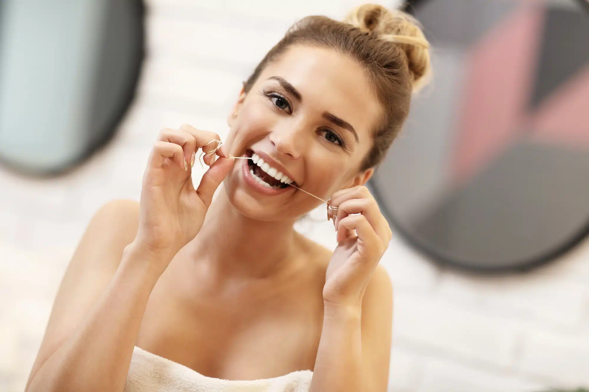 Young woman brushing teeth in bathroom